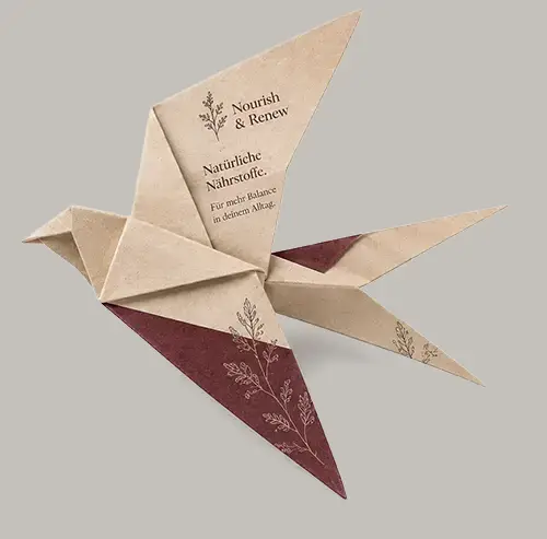 Nourish & Renew Papierflieger aus bedrucktem Papier – Printdesign